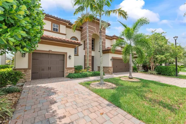 a front view of a house with a yard and trees
