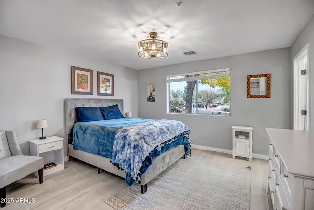 a bedroom with a bed and a chandelier