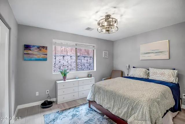 a bedroom with a bed and a chandelier