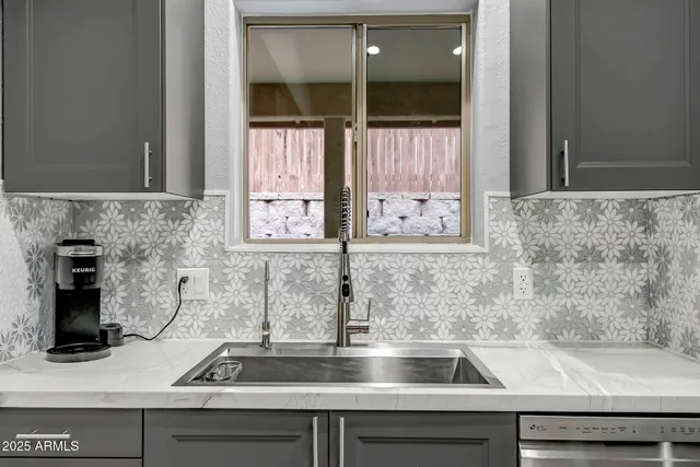 a kitchen with a sink and a window