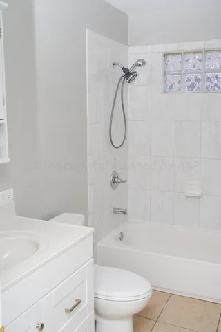 a bathroom with a bathtub toilet and shower