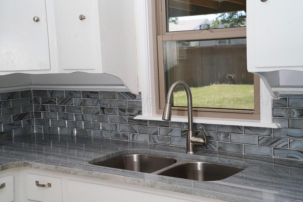 709 North Wells Street Pampa, TX 79065 - Photo 19 of 26 a kitchen with a sink and a window