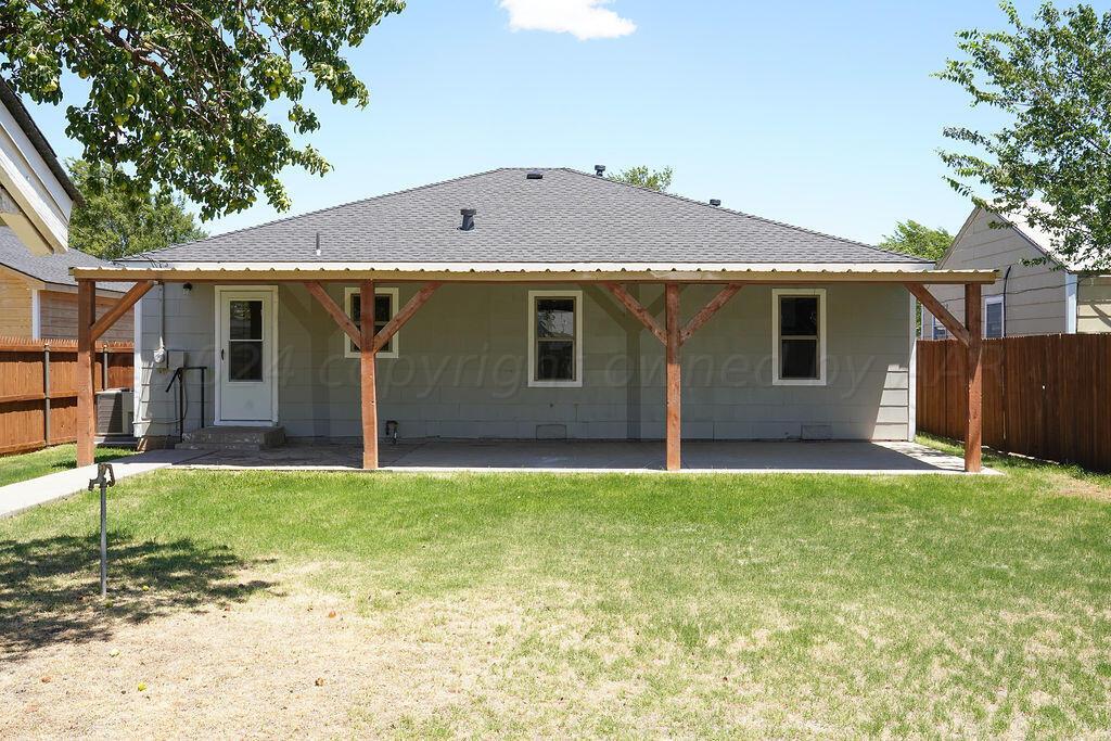 709 North Wells Street Pampa, TX 79065 - Photo 22 of 26 a front view of a house with a yard