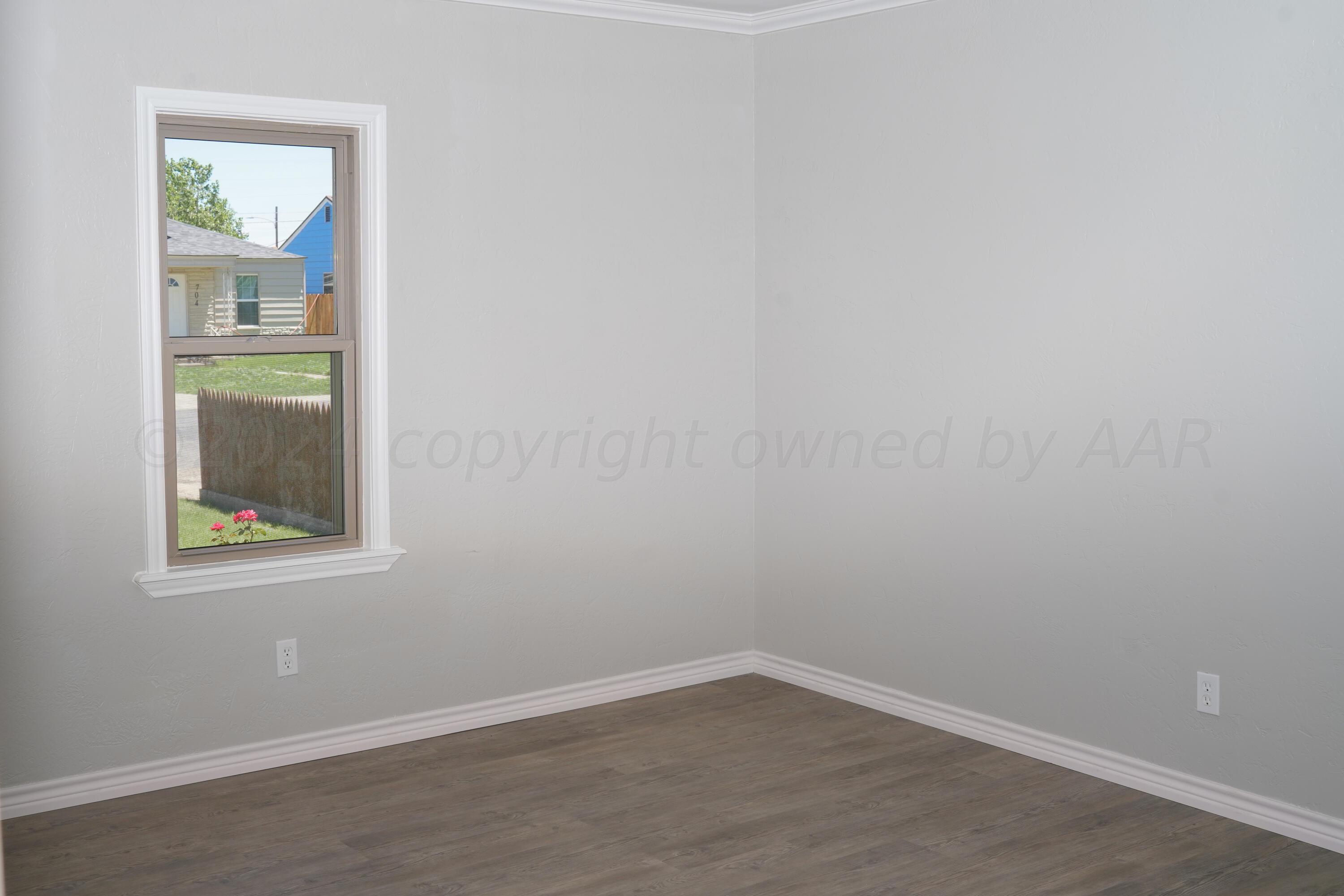 709 North Wells Street Pampa, TX 79065 - Photo 9 of 26 an empty room with a window