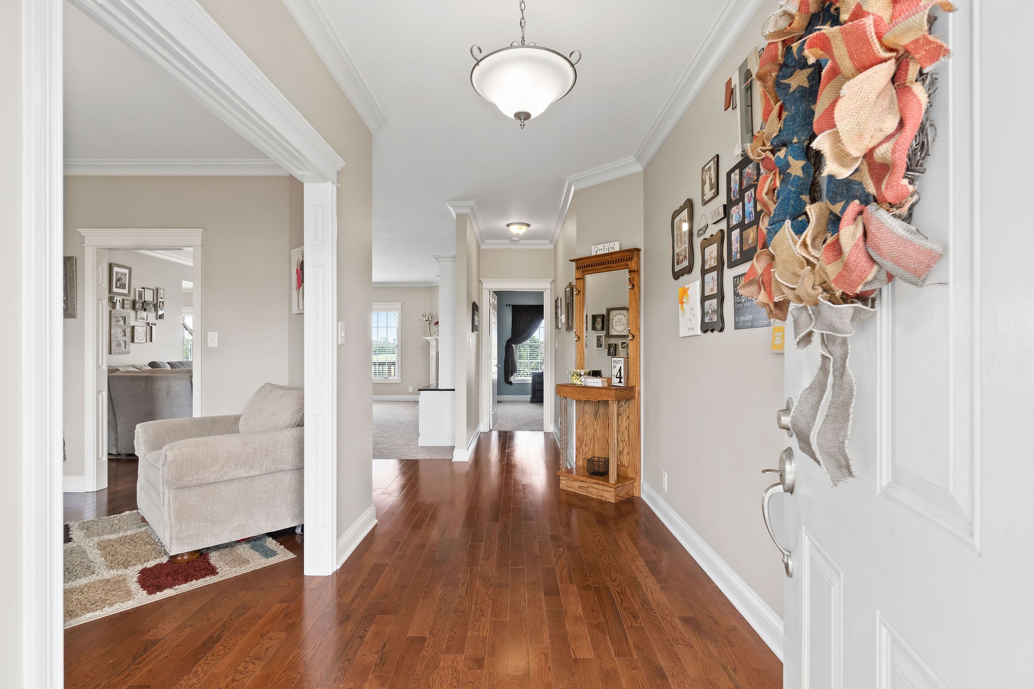 701 7 Mile Ferry Road Cunningham, TN 37052 - Photo 2 of 36 a view of a hallway with wooden floor windows and a chandelier