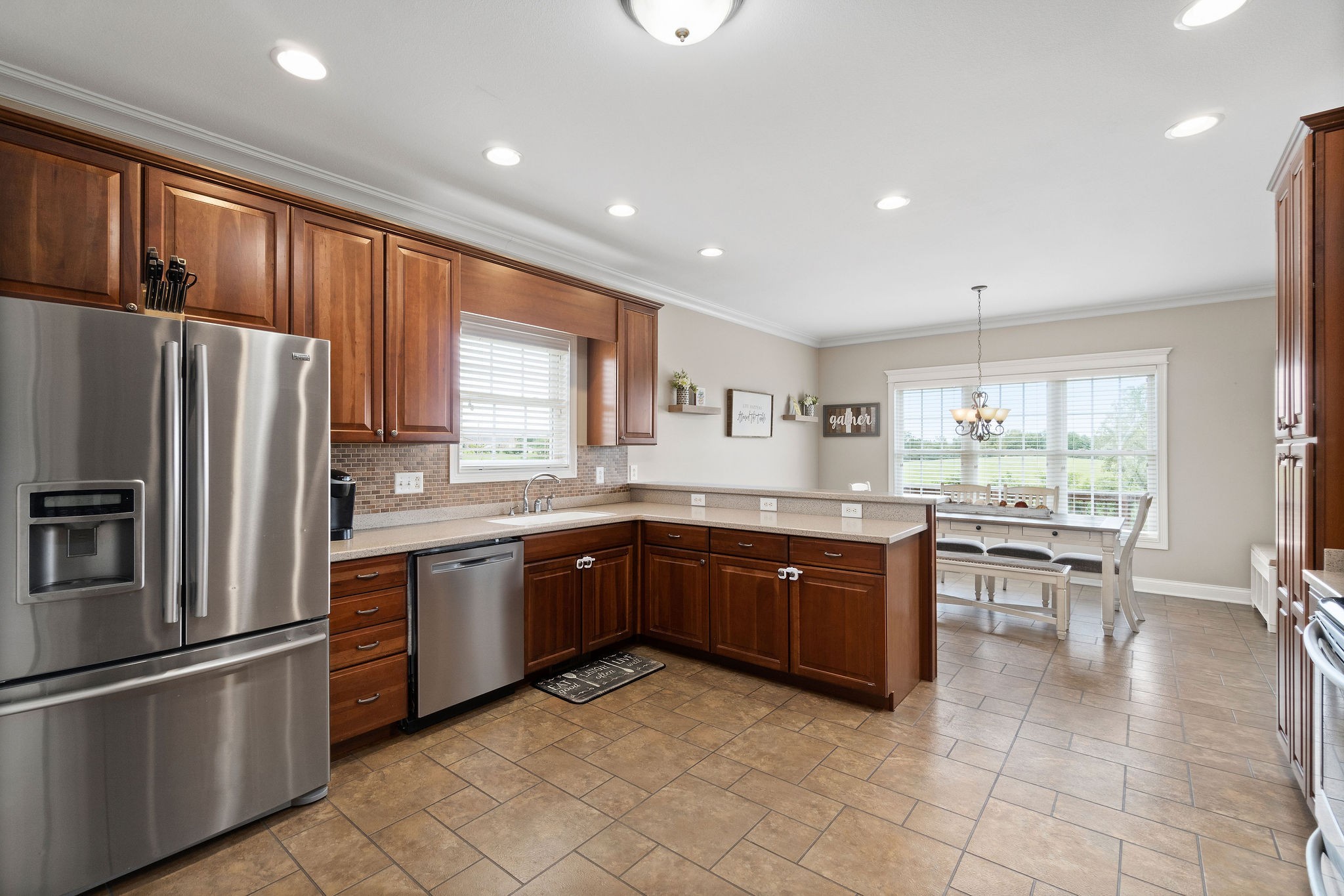 701 7 Mile Ferry Road Cunningham, TN 37052 - Photo 11 of 36 a kitchen with stainless steel appliances granite countertop a refrigerator a sink dishwasher a oven with a dining table and chairs