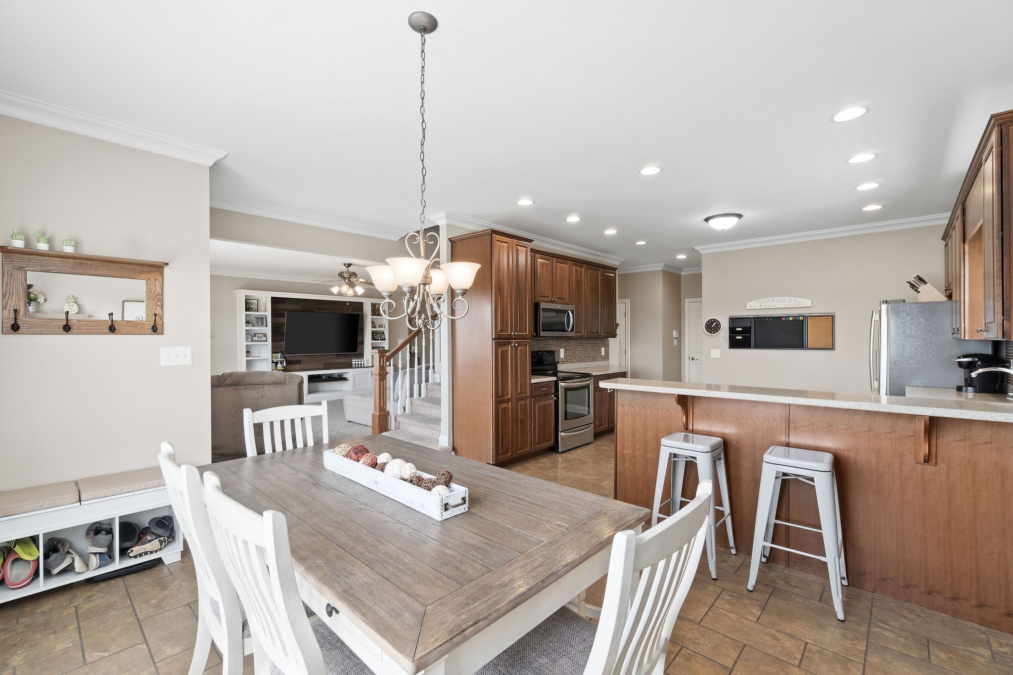 701 7 Mile Ferry Road Cunningham, TN 37052 - Photo 12 of 36 a kitchen with stainless steel appliances kitchen island granite countertop a refrigerator a stove a sink a dining table and chairs with wooden floor