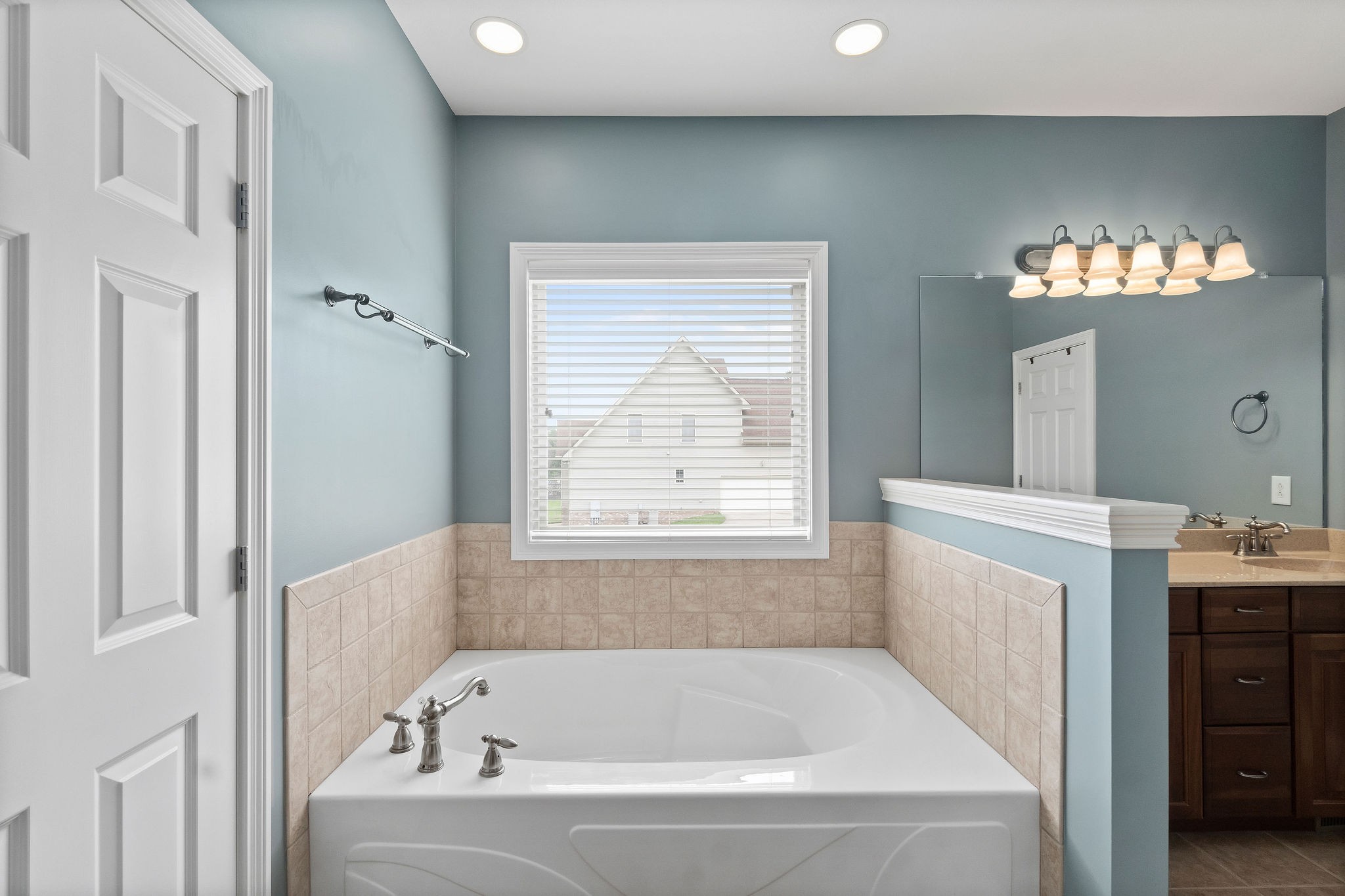 701 7 Mile Ferry Road Cunningham, TN 37052 - Photo 18 of 36 a white bath tub sitting in a bathroom next to a window
