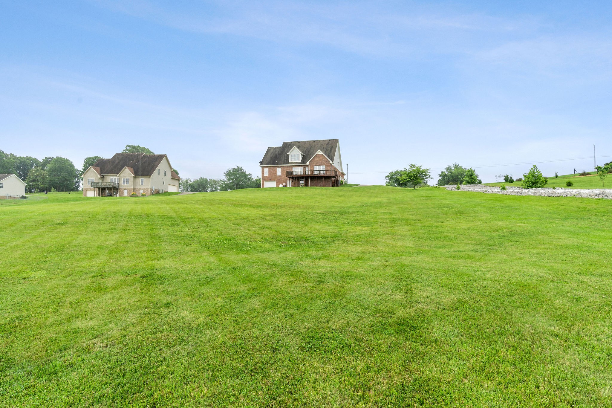 701 7 Mile Ferry Road Cunningham, TN 37052 - Photo 34 of 36 a backyard of a house with lots of green space and mountain view in back