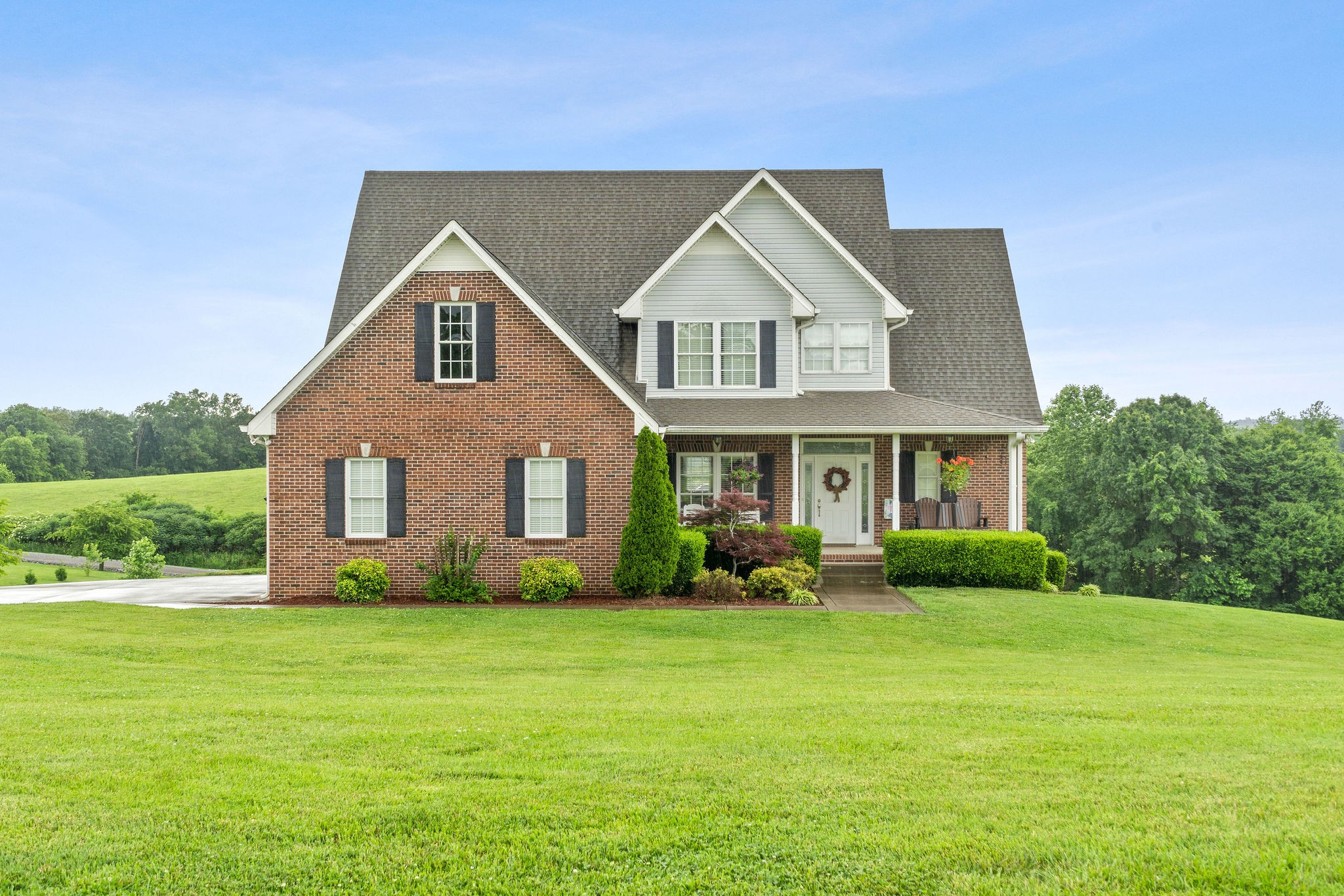 701 7 Mile Ferry Road Cunningham, TN 37052 - Photo 36 of 36 a front view of a house with garden