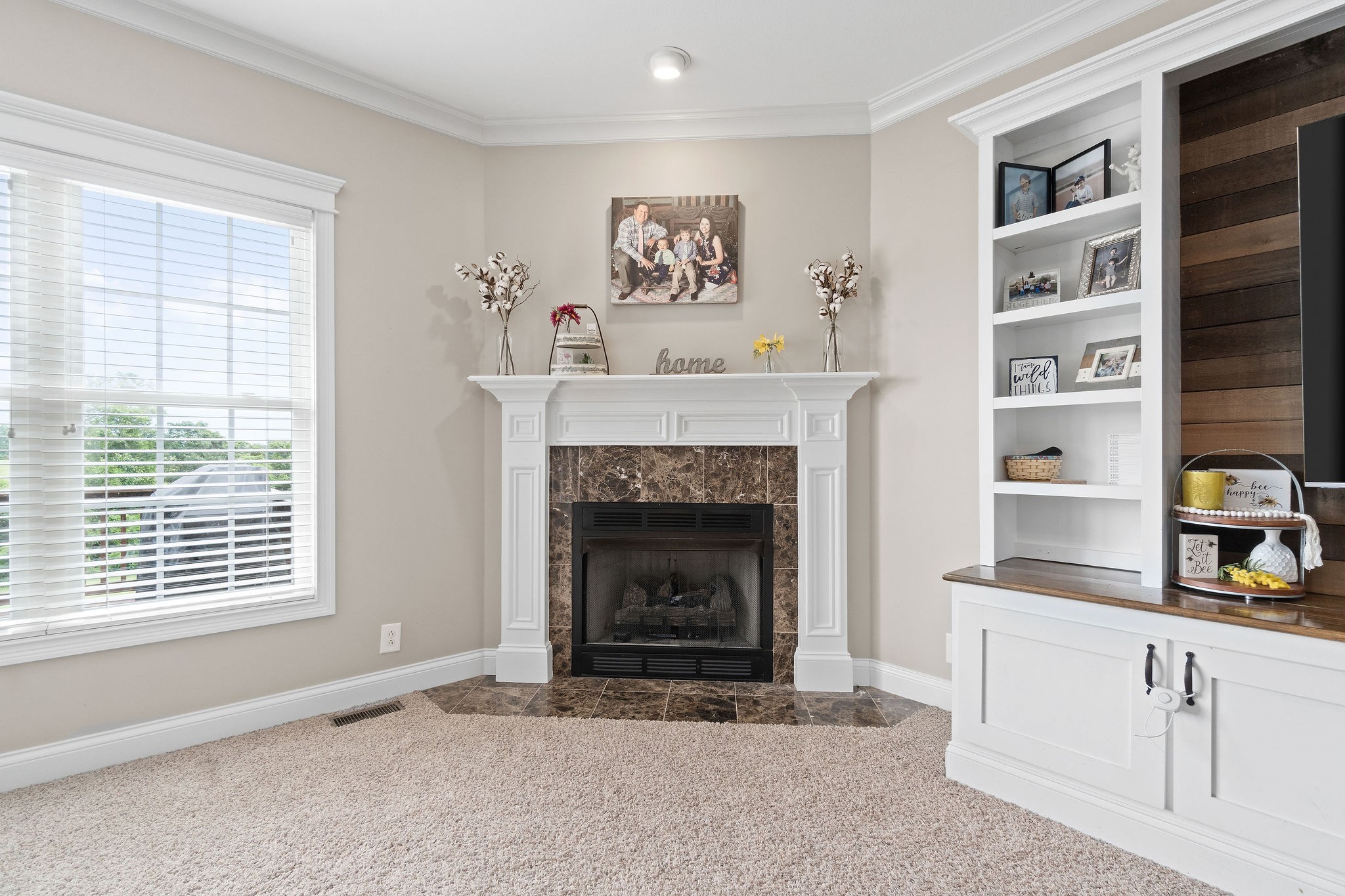 701 7 Mile Ferry Road Cunningham, TN 37052 - Photo 6 of 36 a living room with a fireplace and a window