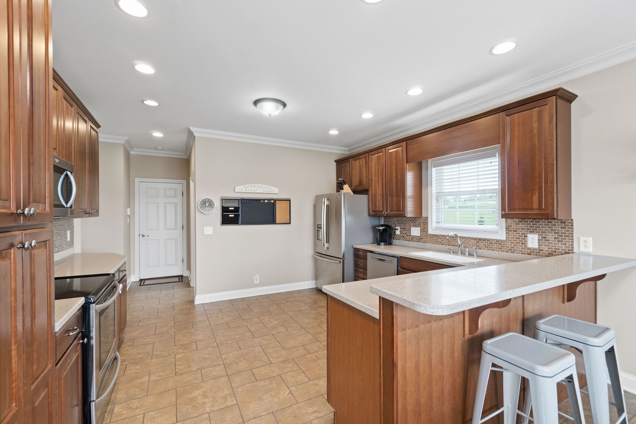 701 7 Mile Ferry Road Cunningham, TN 37052 - Photo 7 of 36 a large kitchen with a large counter top space appliances and windows
