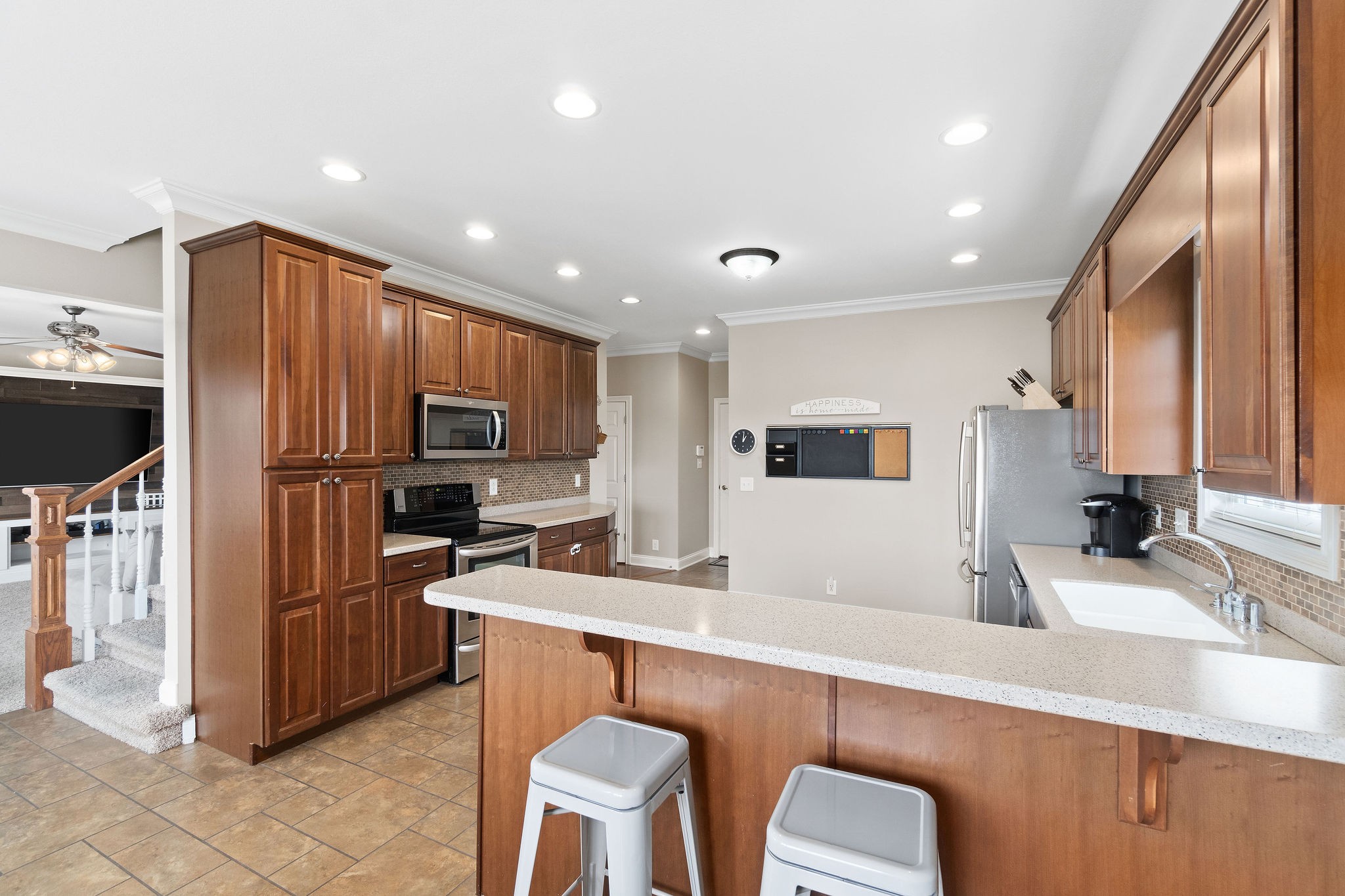 701 7 Mile Ferry Road Cunningham, TN 37052 - Photo 9 of 36 a kitchen with stainless steel appliances granite countertop a sink refrigerator and cabinets
