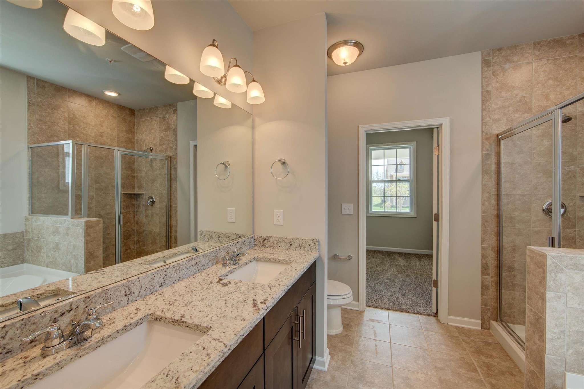 4343 Maxwell Road Antioch, TN 37013 - Photo 20 of 31 a bathroom with a granite countertop sink a large mirror and a shower