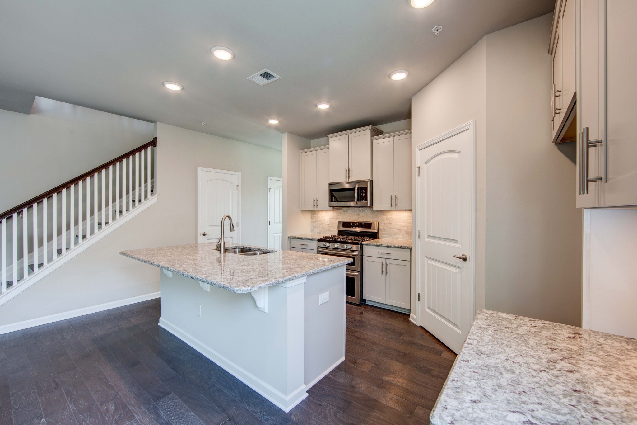 4343 Maxwell Road Antioch, TN 37013 - Photo 9 of 31 a kitchen with stainless steel appliances kitchen island granite countertop a refrigerator oven a sink dishwasher and white cabinets with wooden floor