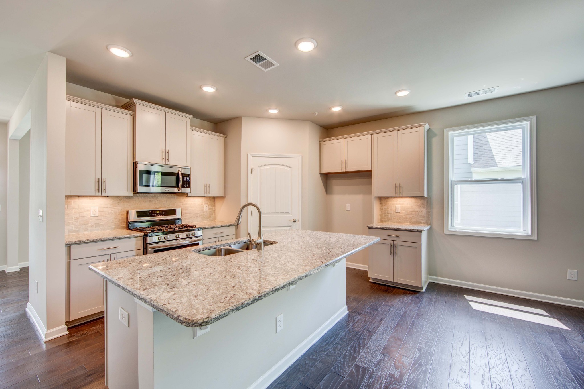 4343 Maxwell Road Antioch, TN 37013 - Photo 10 of 31 a kitchen with stainless steel appliances granite countertop a sink dishwasher a stove and a refrigerator with wooden floor