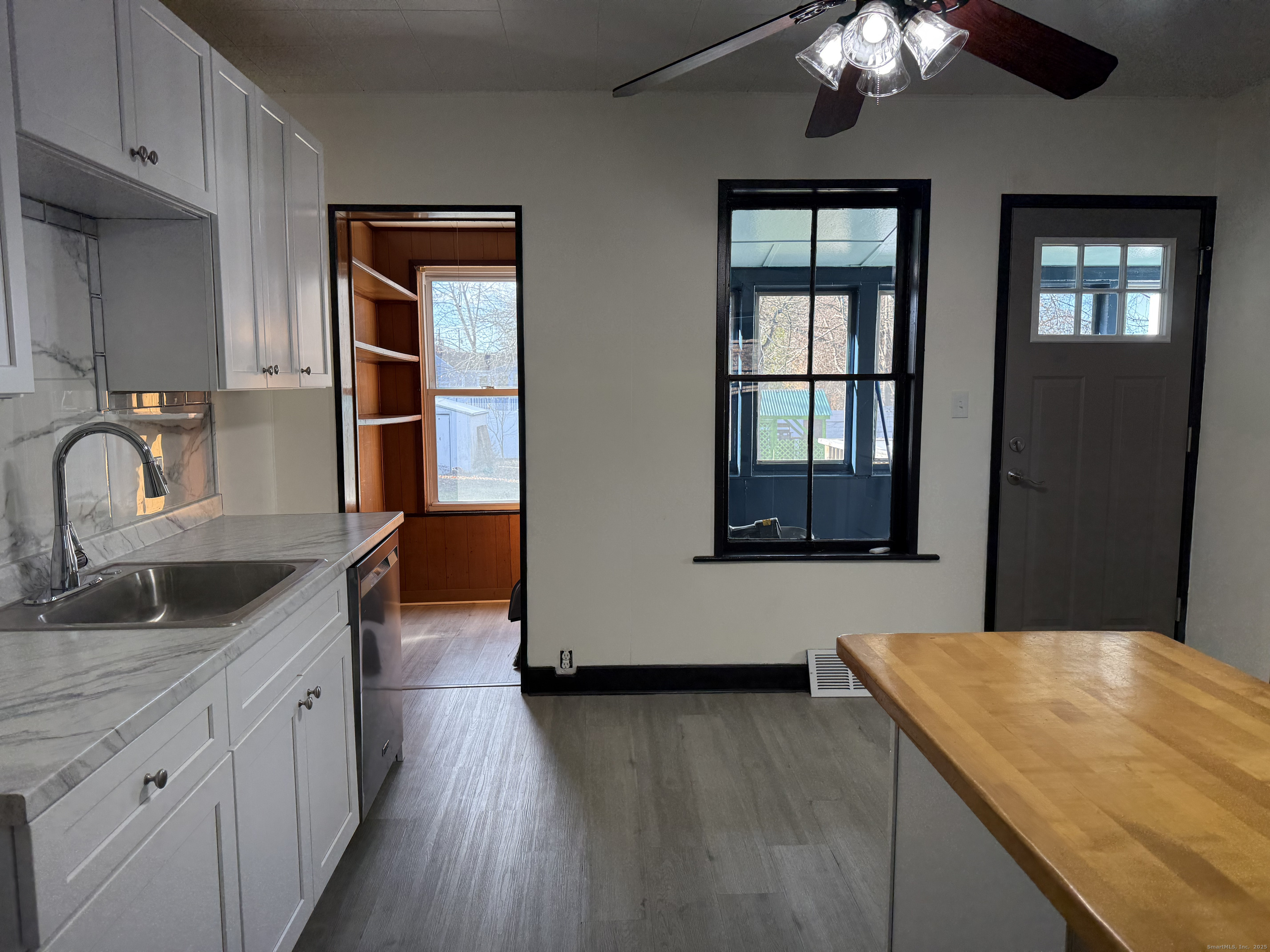 15 Freestone Avenue Portland, CT 06480 - Photo 2 of 13 a kitchen with granite countertop a sink cabinets and wooden floor