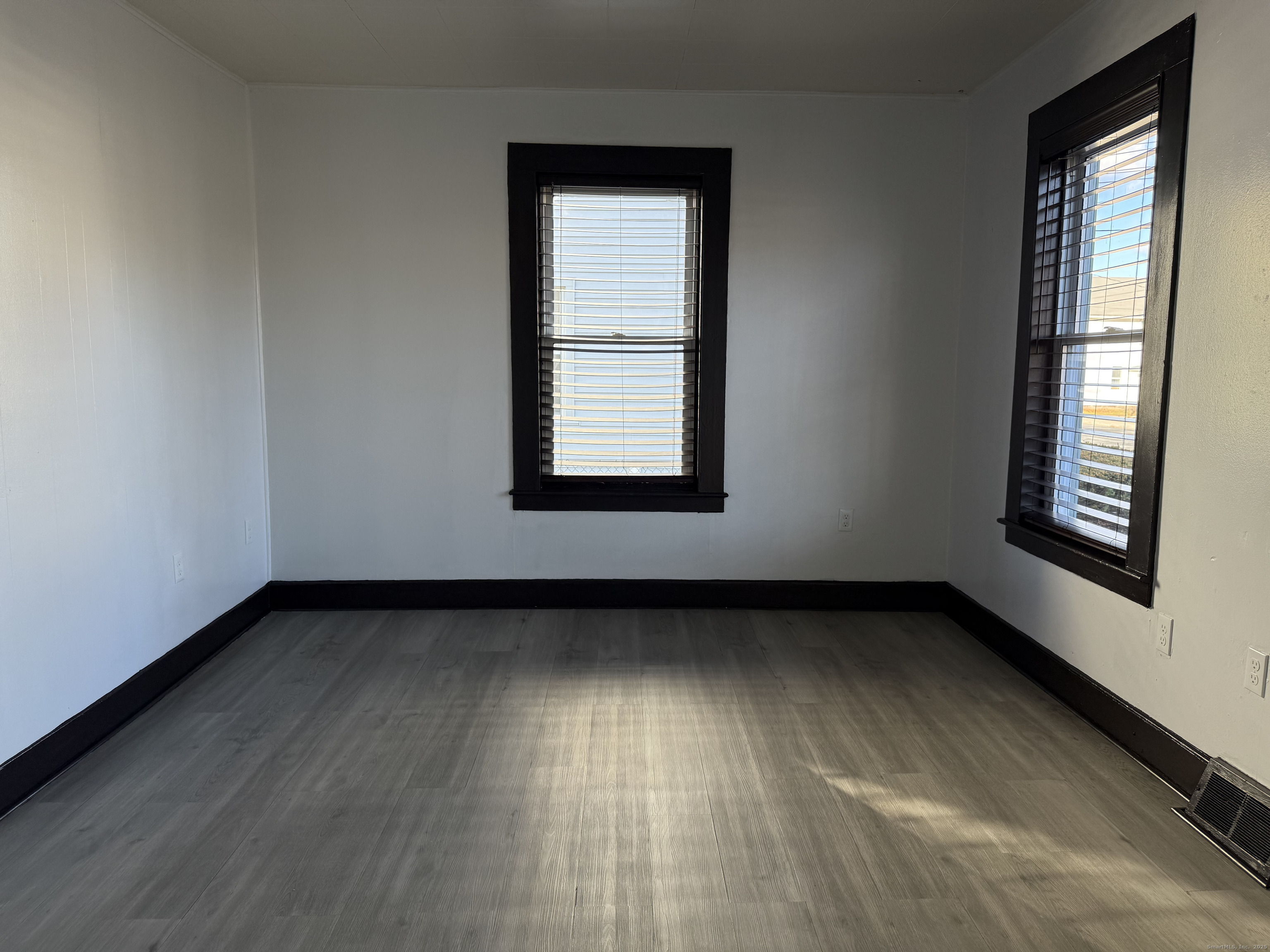 15 Freestone Avenue Portland, CT 06480 - Photo 7 of 13 an empty room with wooden floor and windows