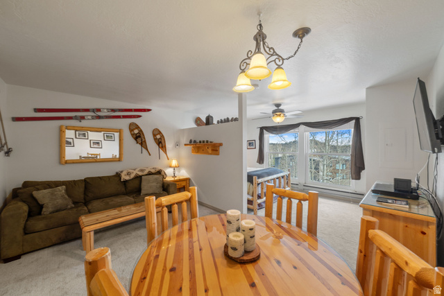 150 Ridgeview Street, Unit 117 Brian Head, UT 84719 - Photo 16 of 20 Dining space featuring light carpet, ceiling fan, suspended lighting, and vaulted ceiling