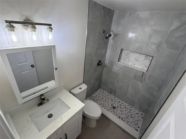 a bathroom with a tub and shower
