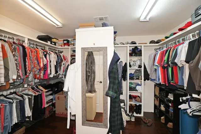 a view of walk in closet with clothes