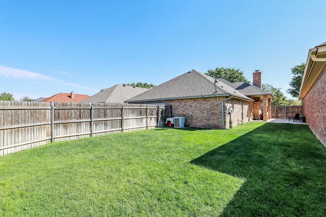 a view of a house with a yard and sitting area