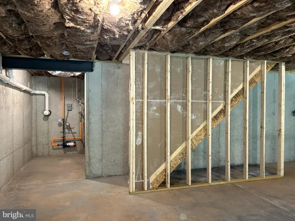a view of water heater room with wooden floor