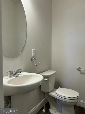 a bathroom with a sink toilet and a mirror