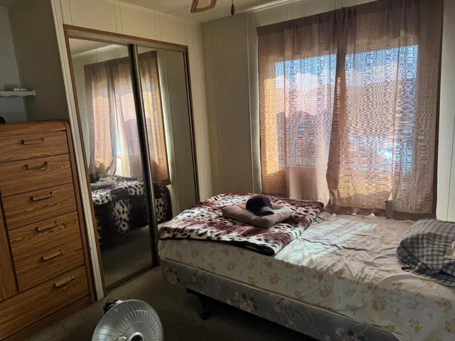 a bedroom with a bed and a window