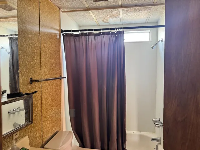 a bathroom with a shower and a mirror