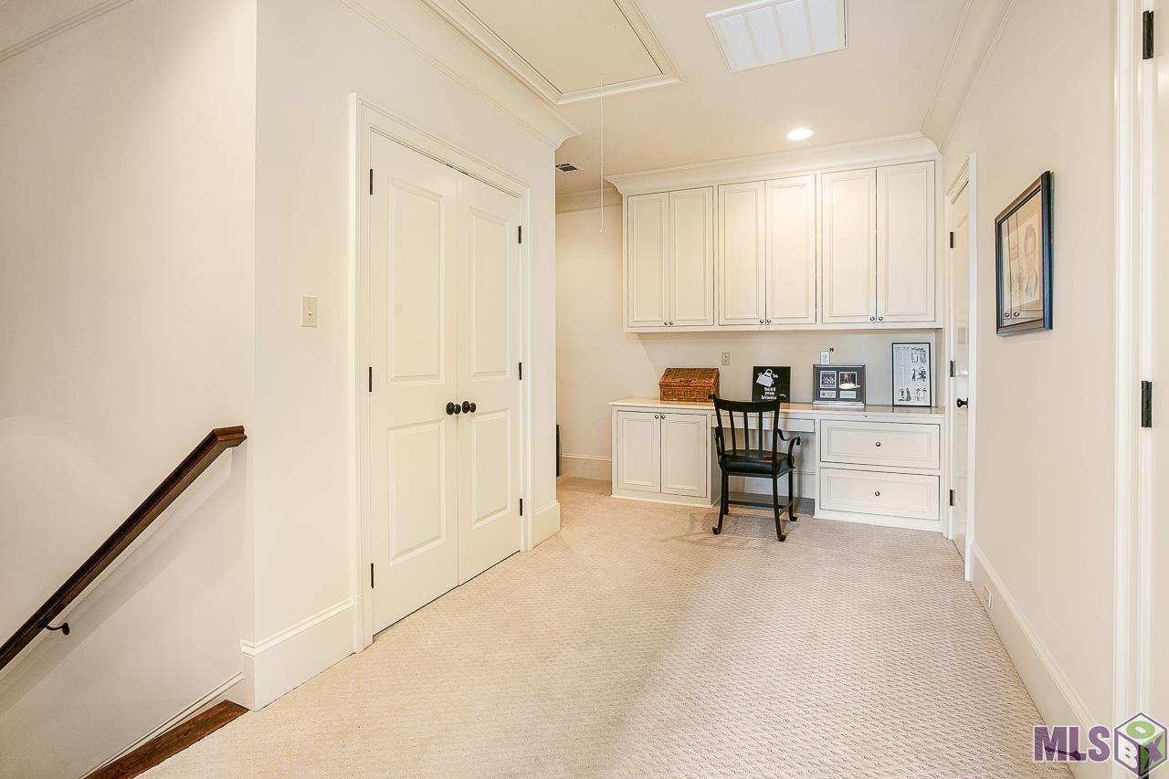 26 Country Club Place Baton Rouge, LA 70809 - Photo 45 of 50 LANDING ON 3RD FLOOR HAS 2 CLOSETS FULL BATH AND BUILT IN DESK
