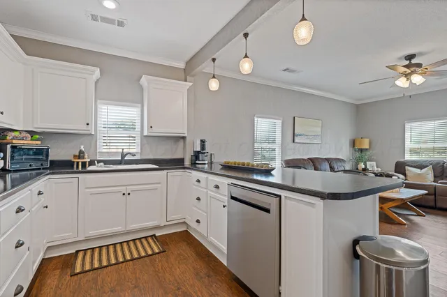a kitchen with a sink stove and cabinets