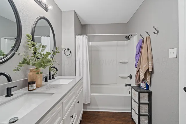 a bathroom with a double vanity sink and a mirror