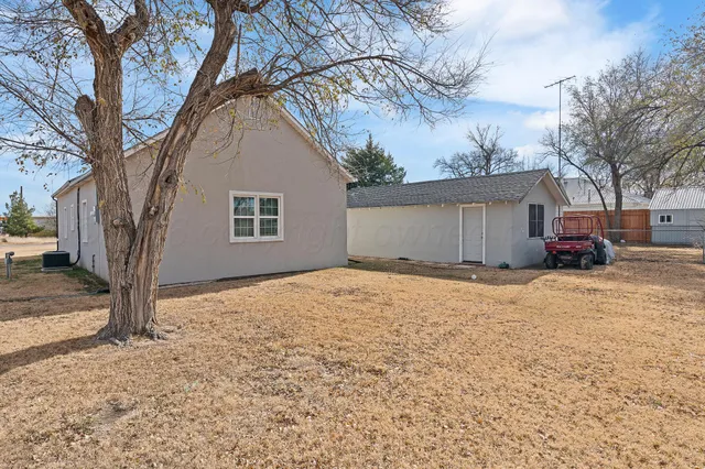 a house covered with snow on the roadside