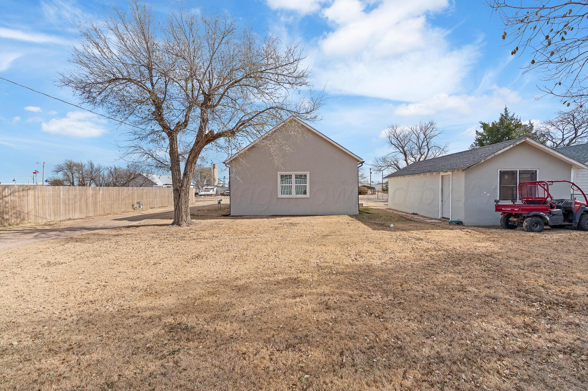 104 South Cherry Street Claude, TX 79019 - Photo 7 of 22 a house with trees in front of it