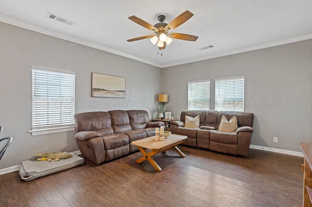 a living room with furniture a rug and a window