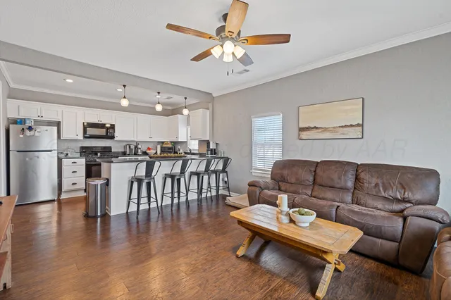 a living room with furniture and kitchen view