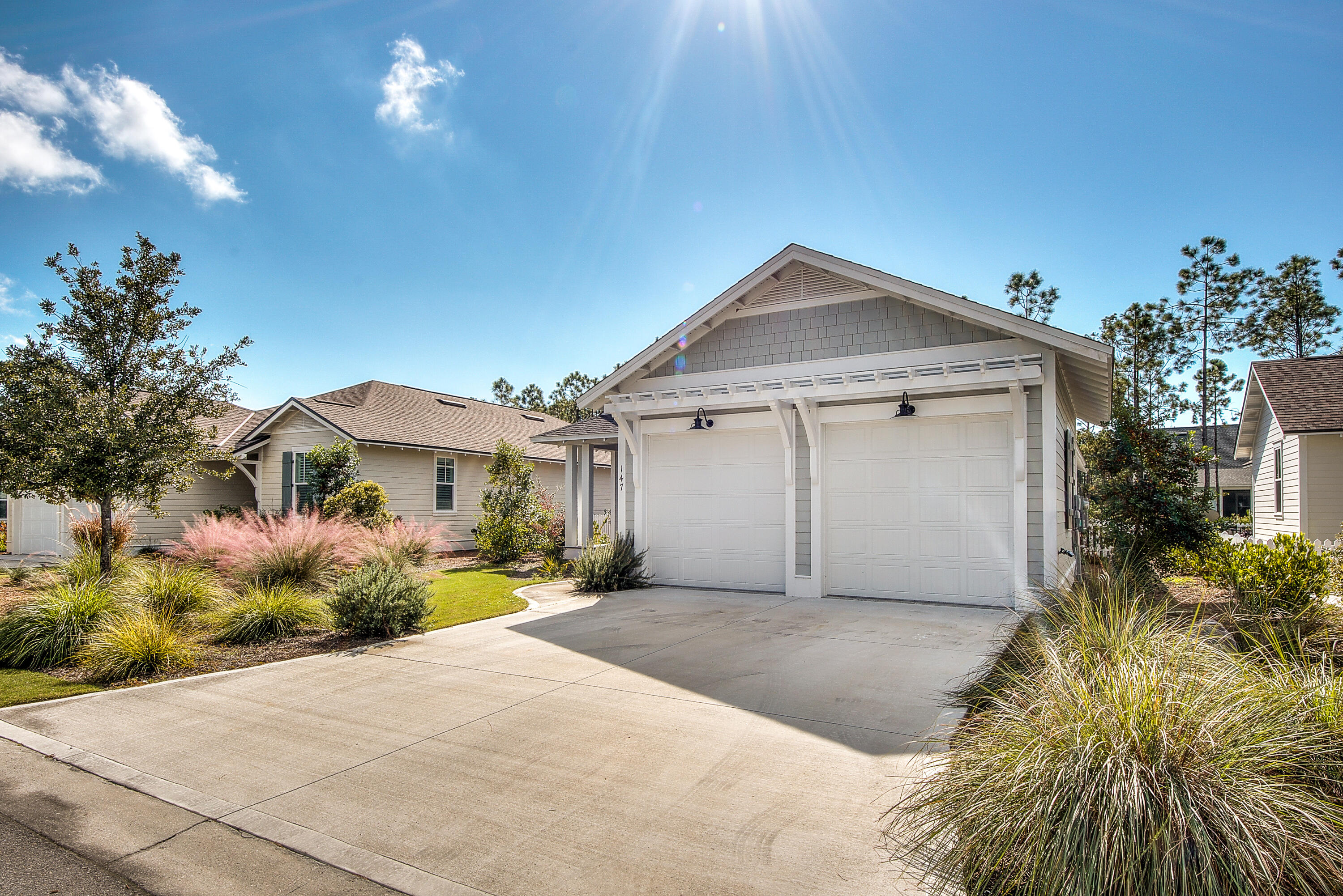 147 Jack Knife Drive Inlet Beach, FL 32461 - Photo 2 of 15 a front view of a house with a yard and garage