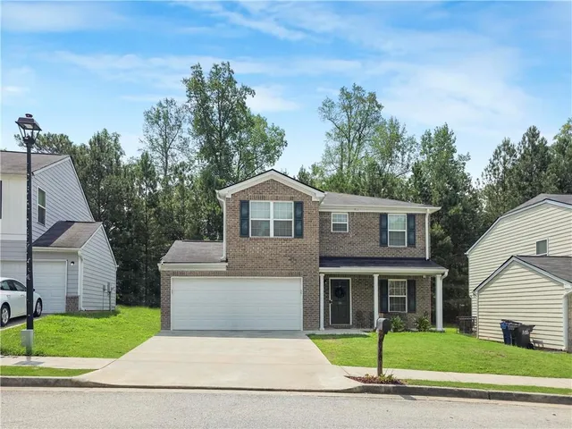 a house that has a tree in front of it