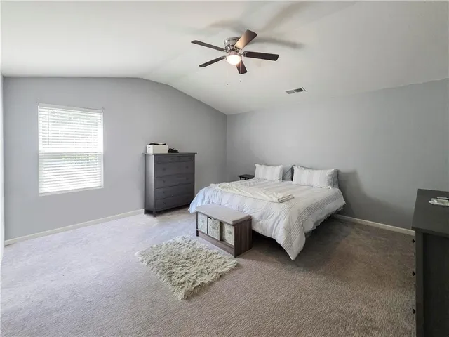 a view of walk in closet with clothes
