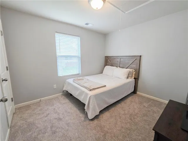 a bathroom with a granite countertop toilet a sink and a mirror
