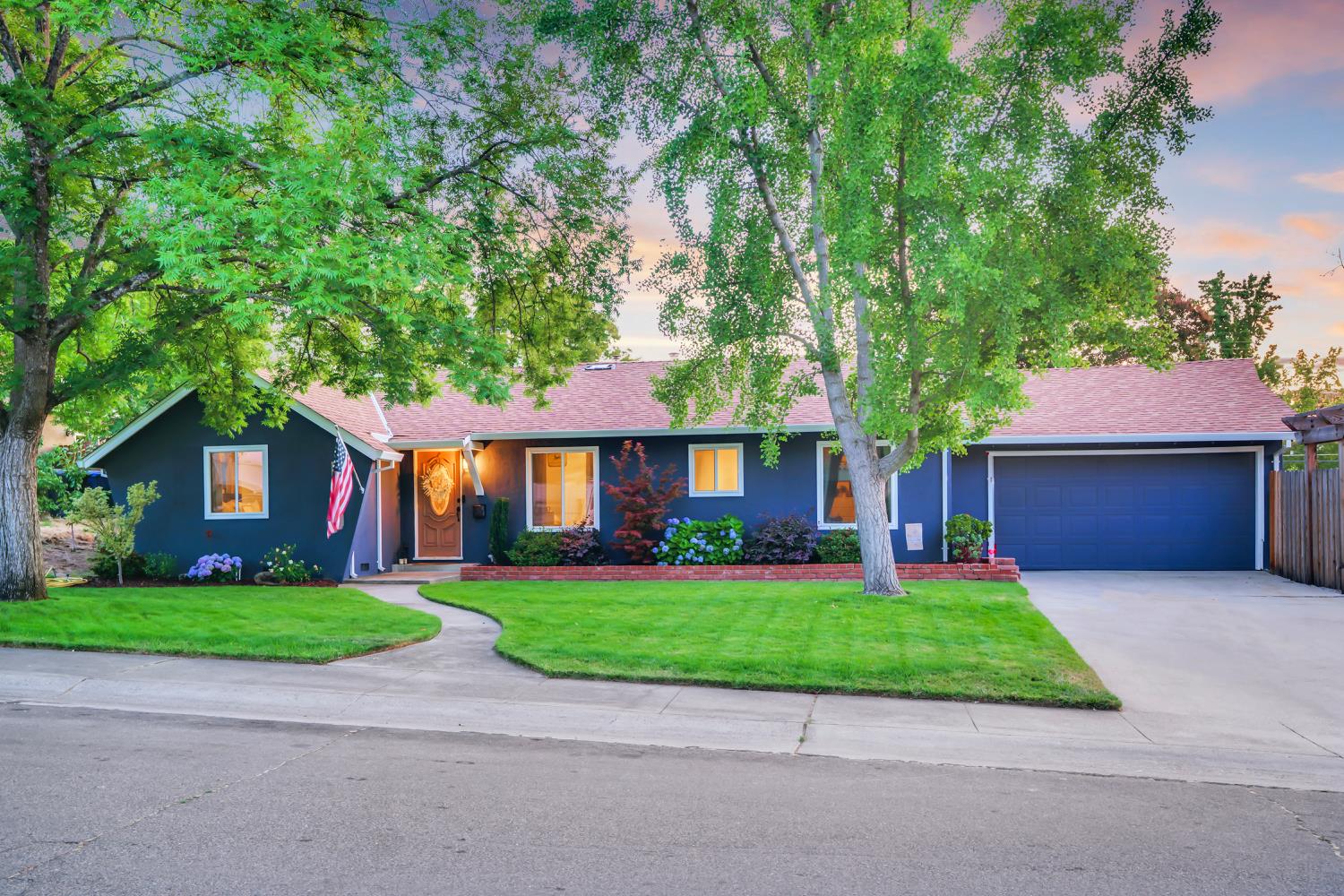 a front view of house with yard and green space