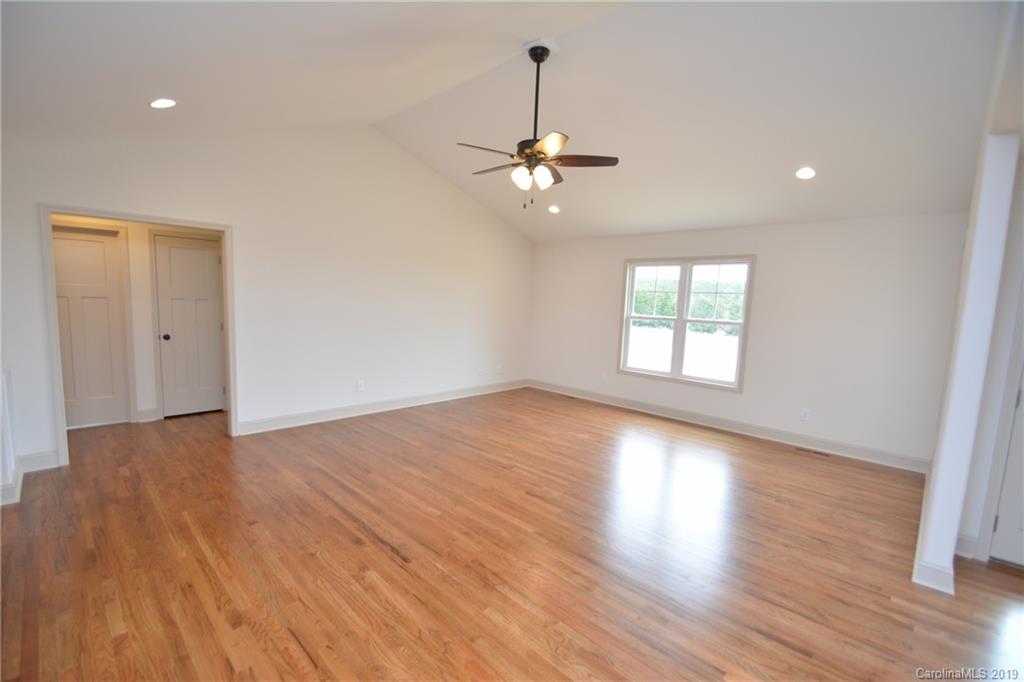 1331 George Brown Road Crouse, NC 28033 - Photo 11 of 39 a view of an empty room with wooden floor ceiling fan and a window