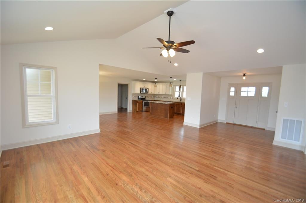 1331 George Brown Road Crouse, NC 28033 - Photo 12 of 39 a view of empty room with wooden floor and kitchen view