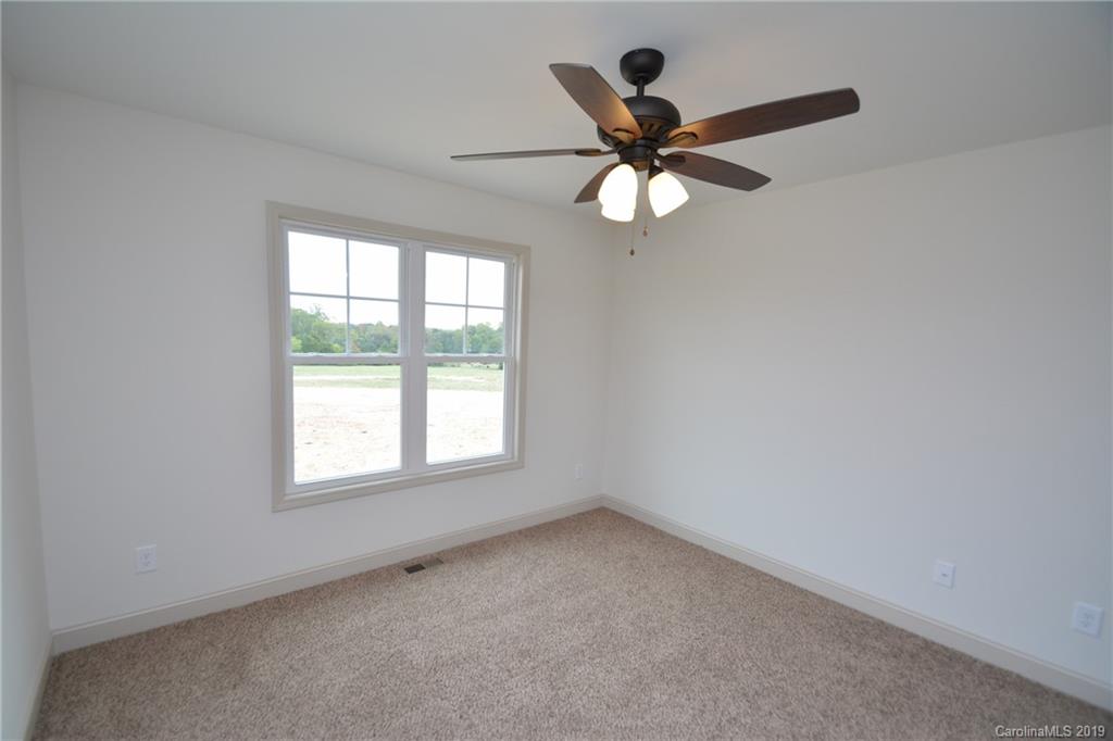 1331 George Brown Road Crouse, NC 28033 - Photo 18 of 39 an empty room with a window and a fan