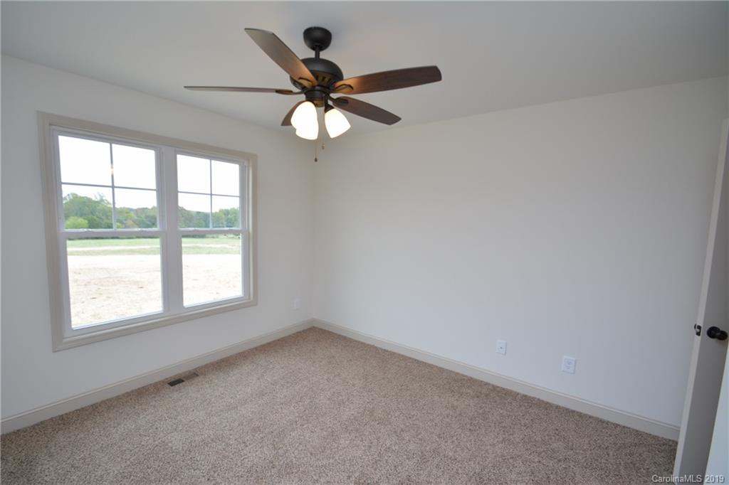 1331 George Brown Road Crouse, NC 28033 - Photo 19 of 39 an empty room with a window and a fan