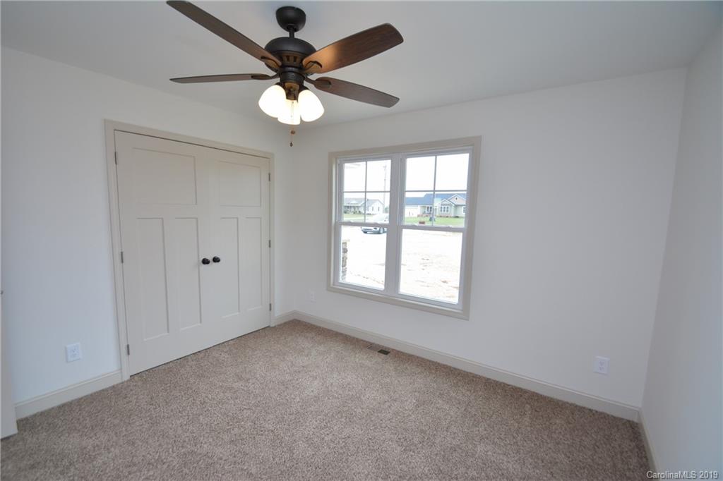 1331 George Brown Road Crouse, NC 28033 - Photo 22 of 39 an empty room with a chandelier fan and windows