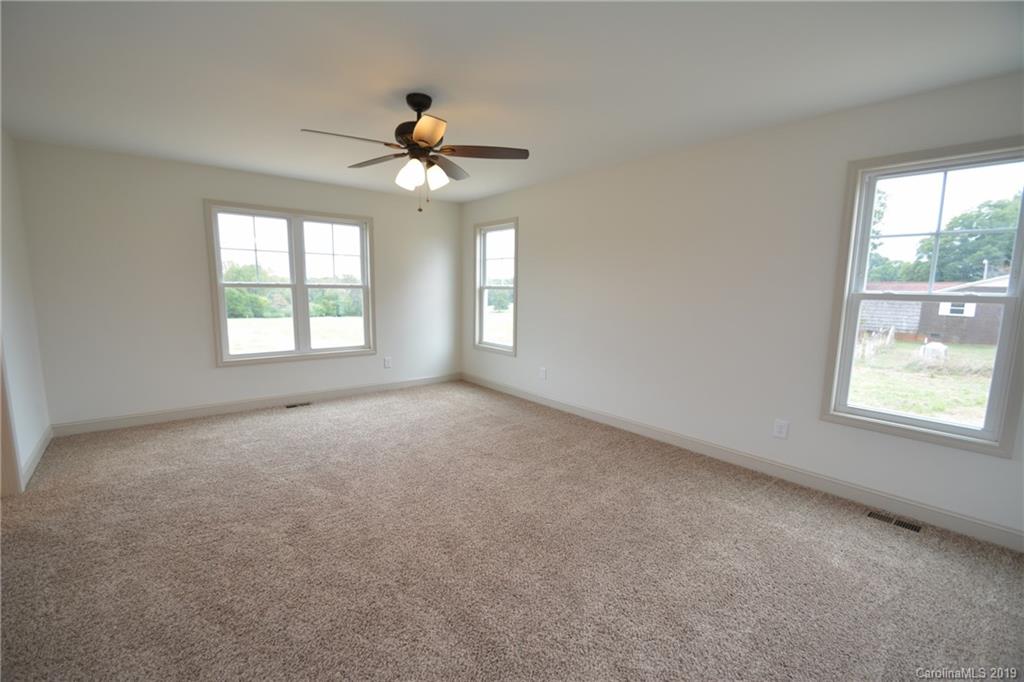 1331 George Brown Road Crouse, NC 28033 - Photo 31 of 39 en empty room with windows and ceiling fan