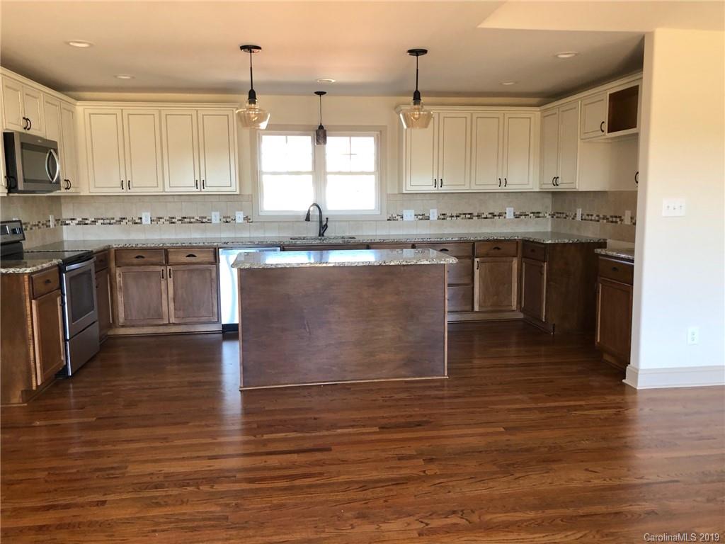 1331 George Brown Road Crouse, NC 28033 - Photo 6 of 39 a kitchen with stainless steel appliances granite countertop a stove top oven a sink a counter space and cabinets