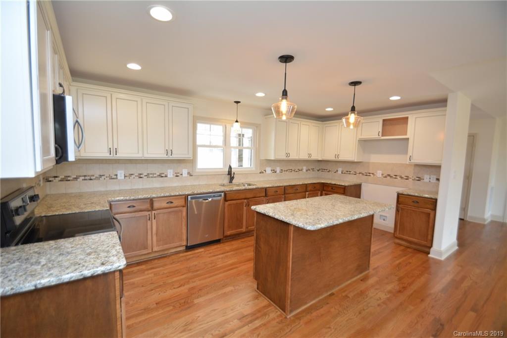 1331 George Brown Road Crouse, NC 28033 - Photo 7 of 39 a kitchen with granite countertop kitchen island wooden floors granite counter tops and a sink